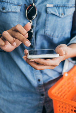Woman on mobile with grocery basket
