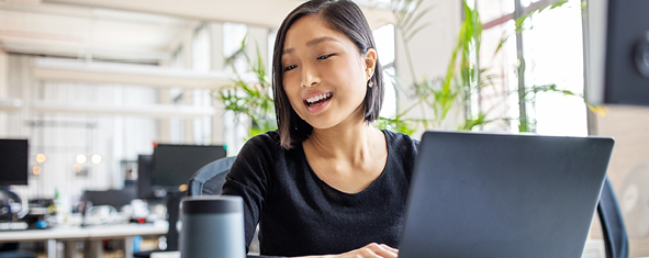 Woman with laptop making voice payment