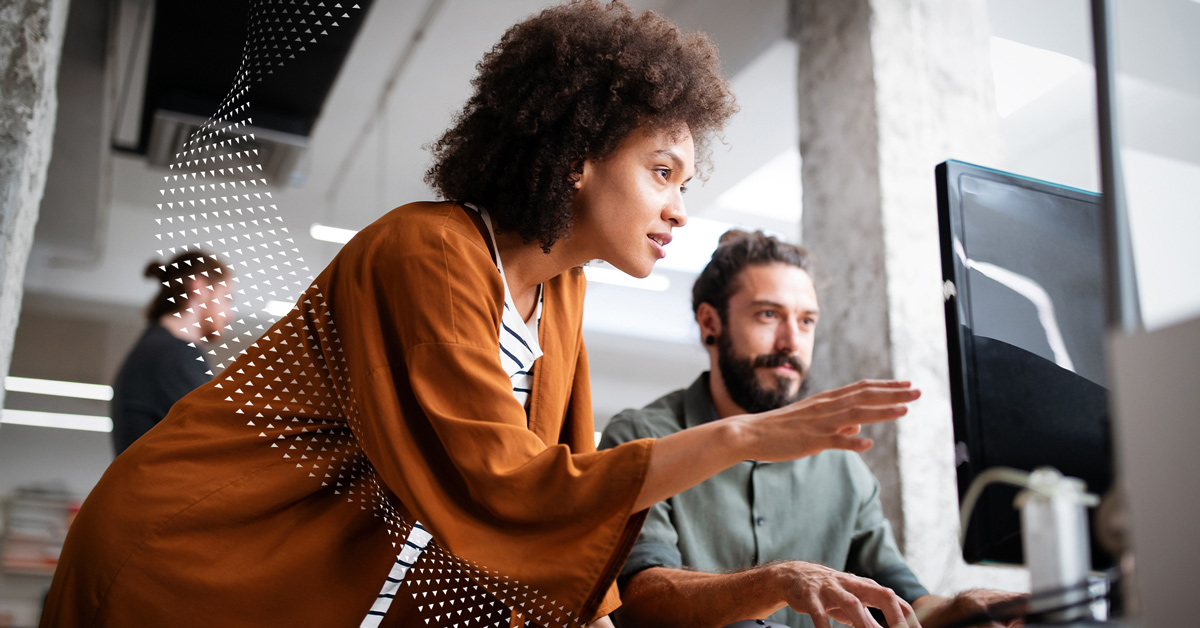 Woman and man looking at computer monitor